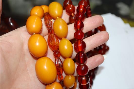 A quantity of amber and faux amber bead necklaces.